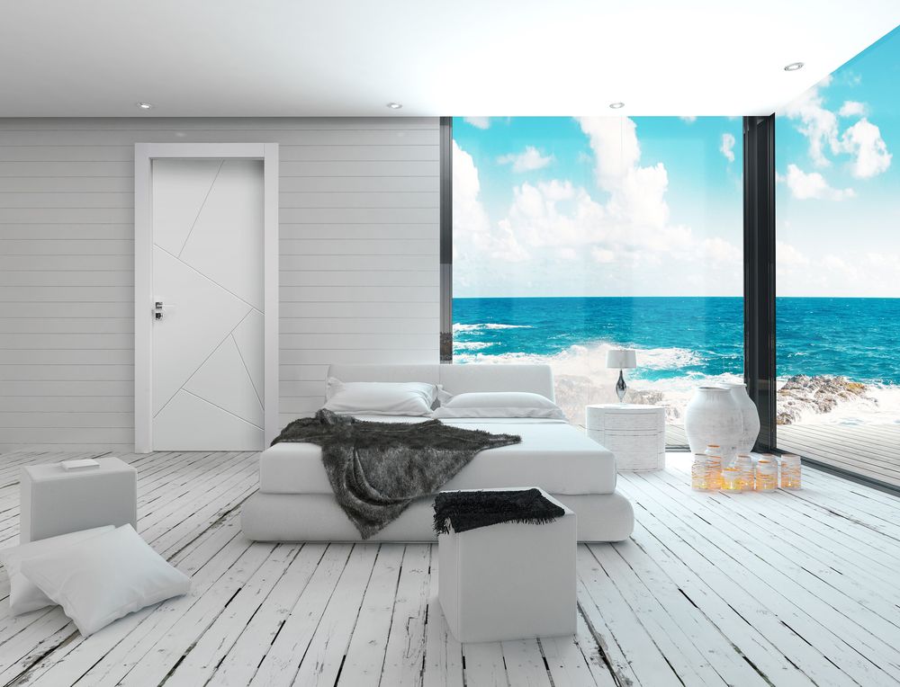 White bedroom interior in a maritime style and sea view